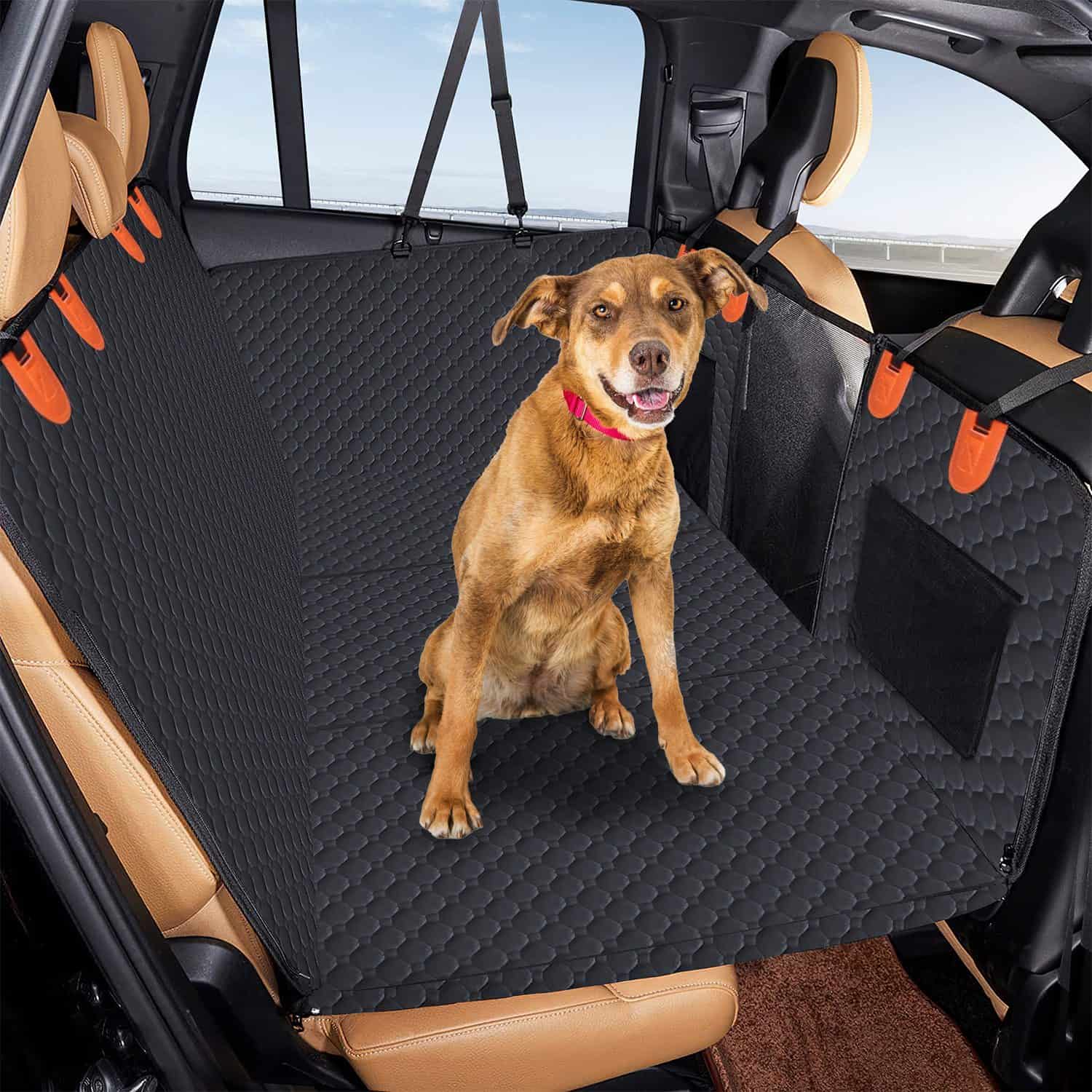 Dog sitting calmly on a car seat cover during a road trip